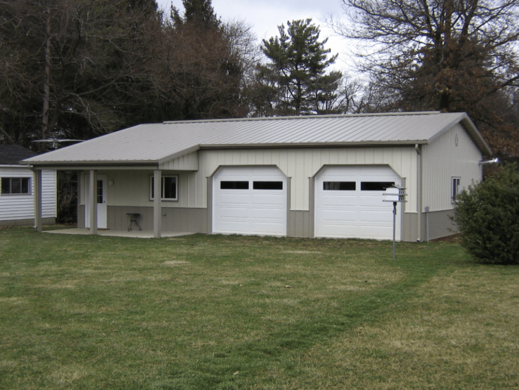 Continuous Roof Pitch Porch Post-frame garage with a continuous roofline extending over the porch area.