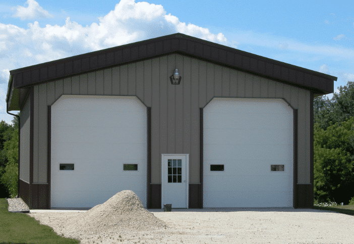 Deep Fascia Overhang Post-frame garage with deep fascia overhangs above large overhead doors.