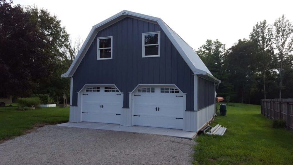 Gambrel Truss Design Pole barn garage with a gambrel truss roof design and upper-level loft space.