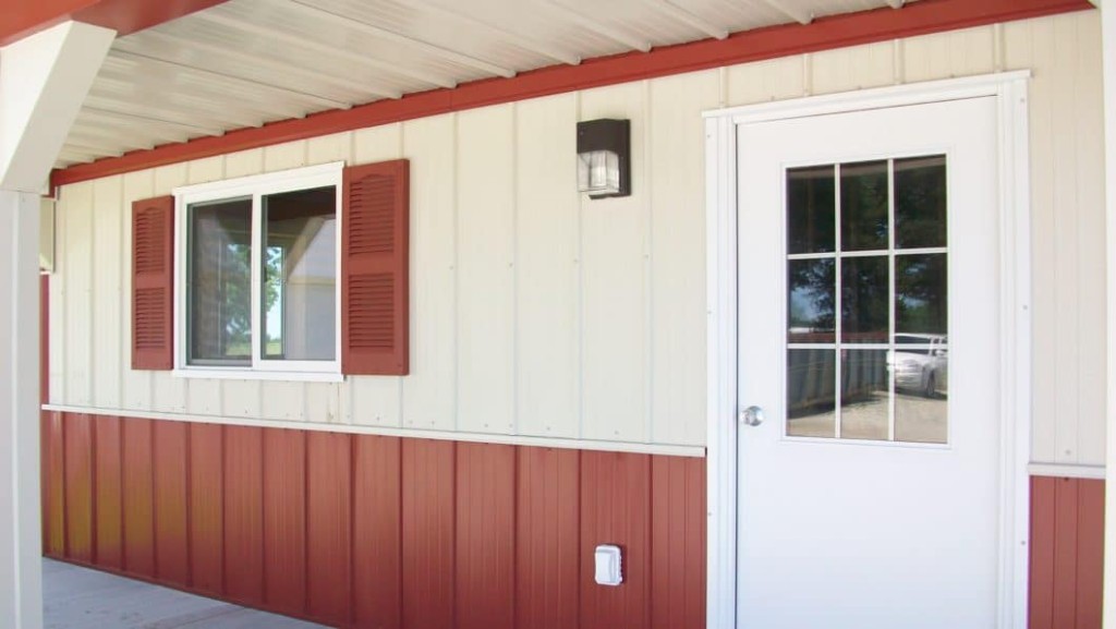 Shutters Post-frame building with decorative shutters beside the windows.