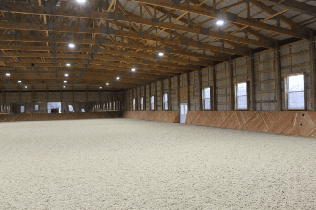 Tapered Arena Liner Post-frame riding arena with tapered arena liner along the interior walls.
