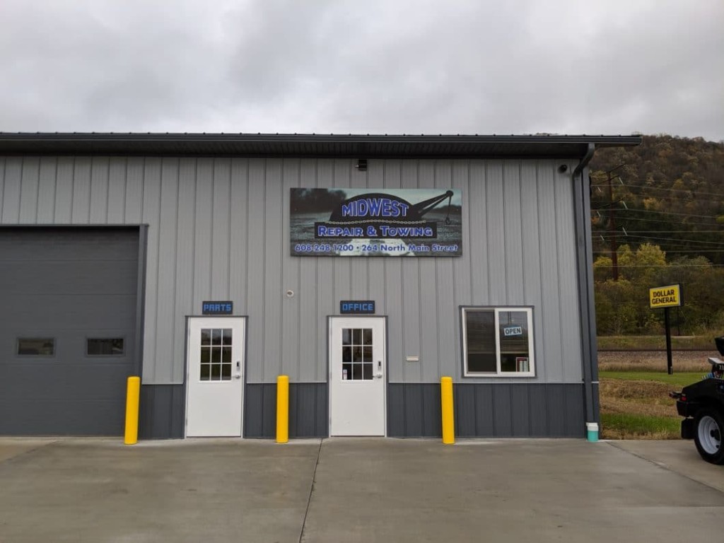 Walk Door Post-frame commercial building with steel walk doors next to overhead door bays.