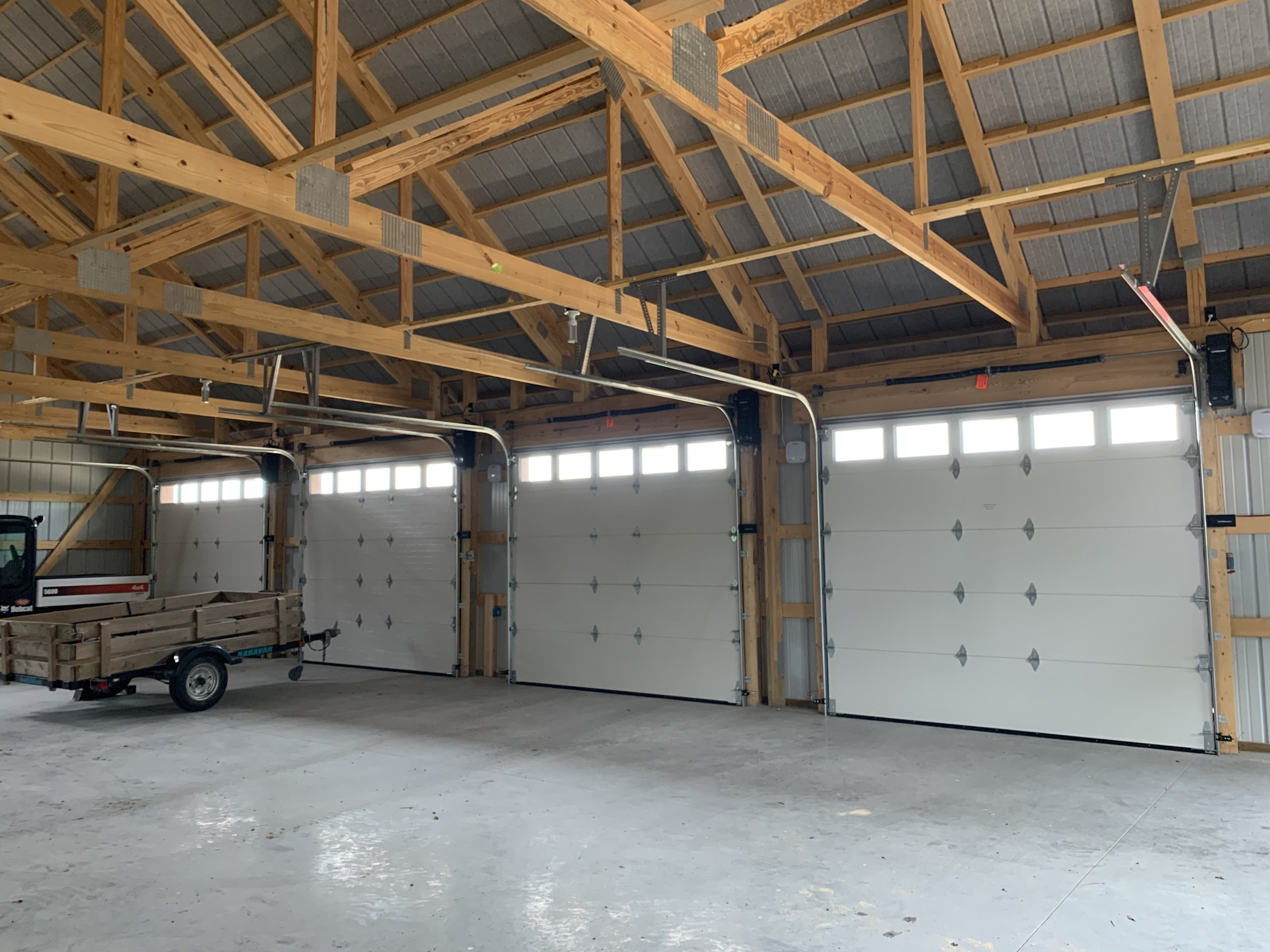 Interior view of four 10′ × 9′ overhead doors in a custom machinery storage building