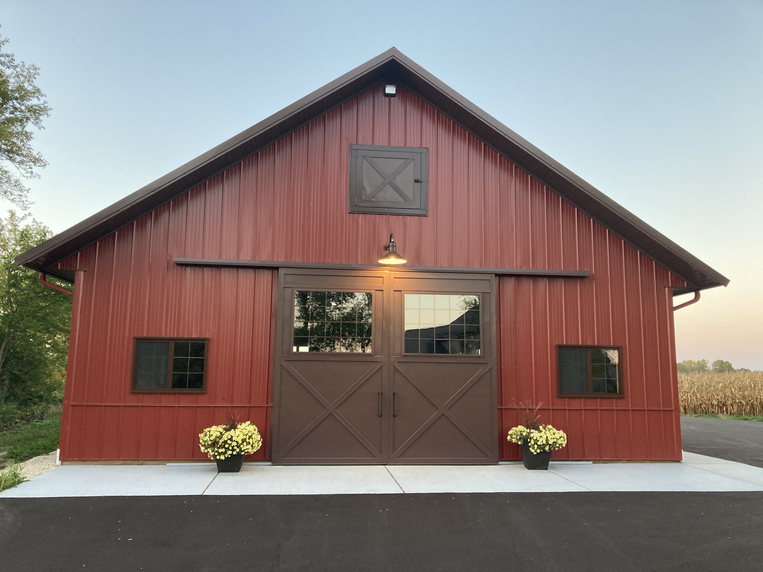 13′ × 11′4″ Touch of Class sliding door on the end wall of a custom machinery storage building