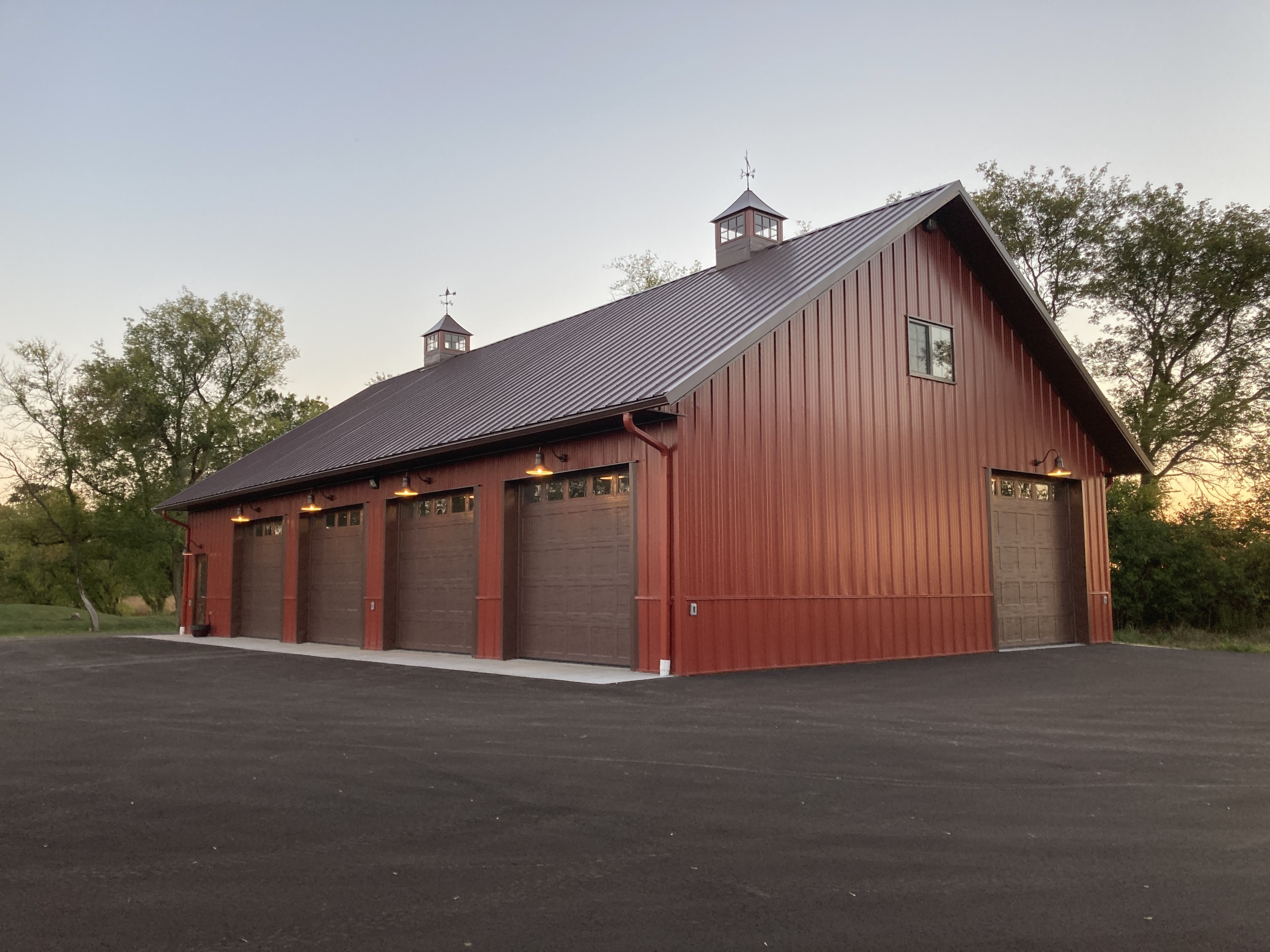 Rear view of custom machinery storage building with 10′ × 10′ overhead door and walk door