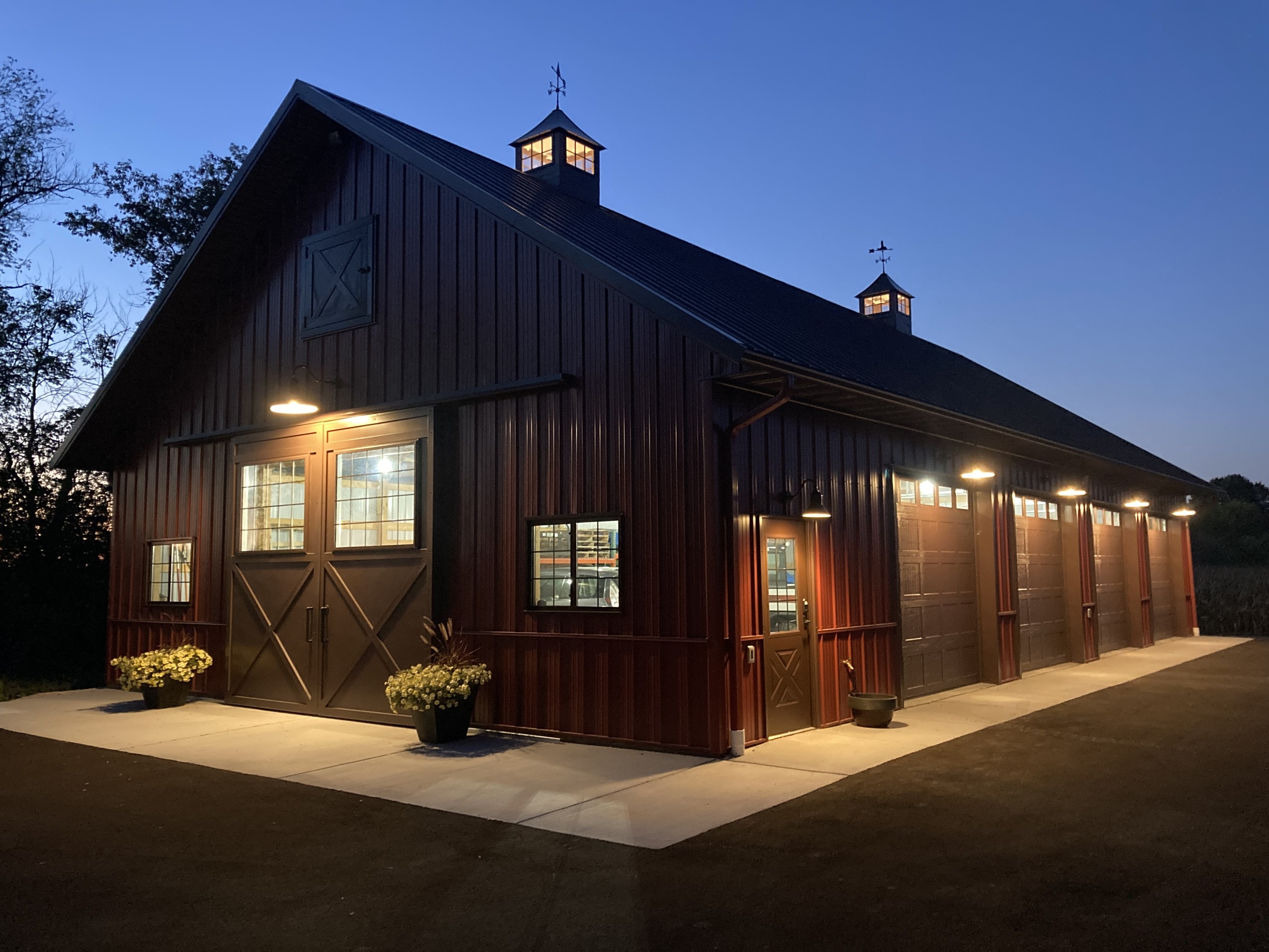 36′ × 64′ pole barn illuminated by exterior lighting after sunset