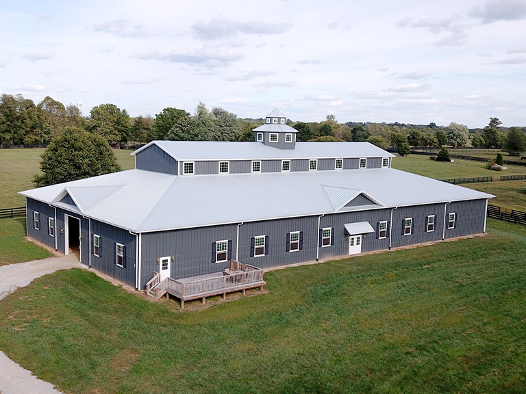 Large Equestrian Facility and Horse Barn | Walters Buildings Large custom equestrian facility with horse stalls, natural lighting, and ventilation for boarding and daily operations