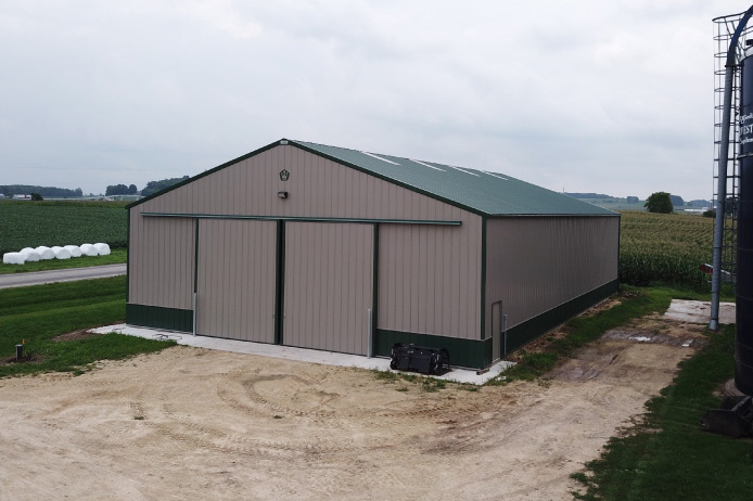 Agricultural equipment storage building with large sliding barn doors