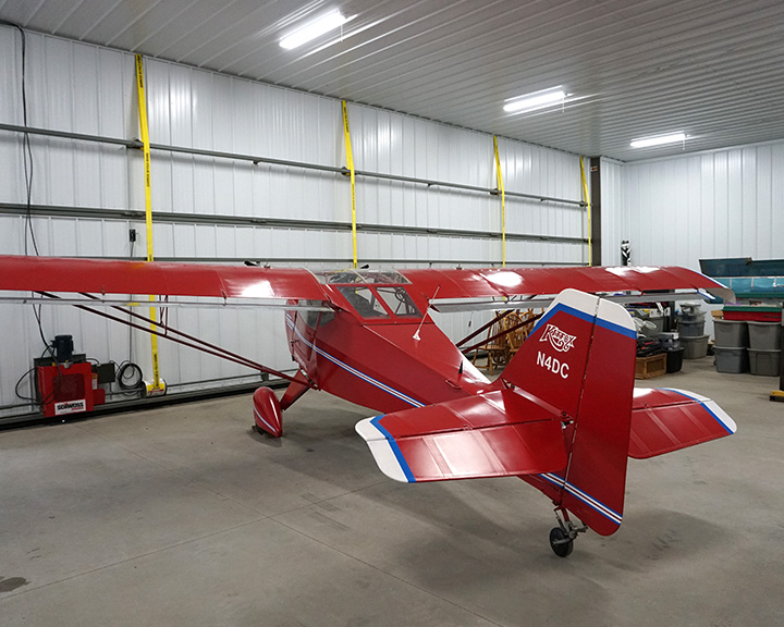 Post-frame airplane hangar interior with steel liner panels and single-engine aircraft storage