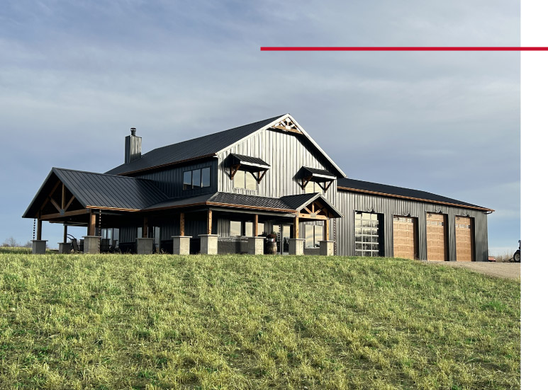 Luxury Barndominium with Covered Porch and Attached Garage Luxury barndominium exterior with black steel siding, covered porch, and attached garage