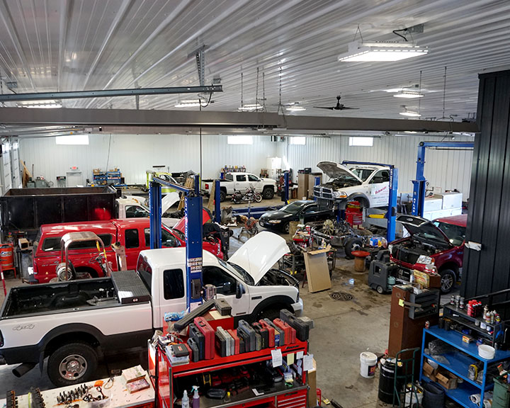 Auto repair shop interior with vehicle lifts, clear-span workspace, and multiple service bays