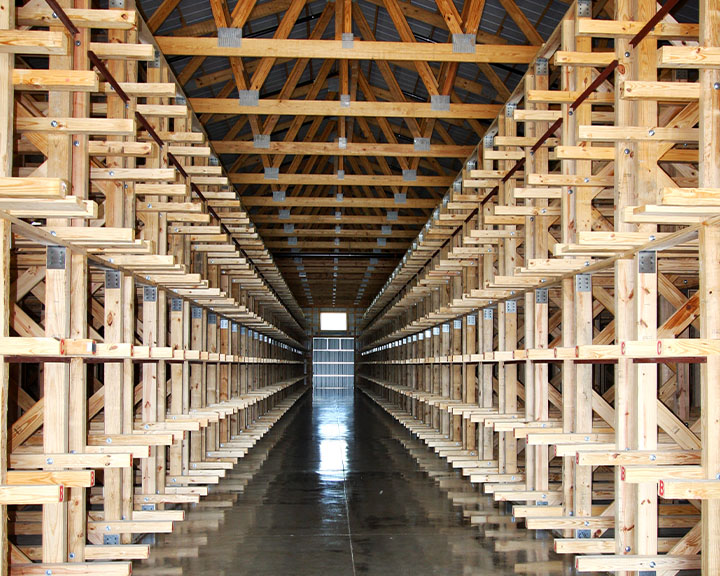 Winery interior with barrel storage racks, clear-span structure, and organized production layout