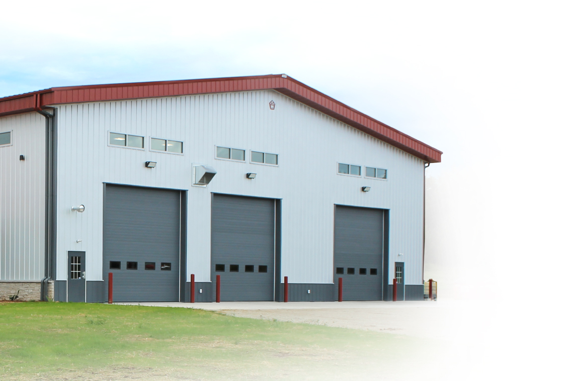 Commercial building with steel siding and multiple overhead doors for equipment access
