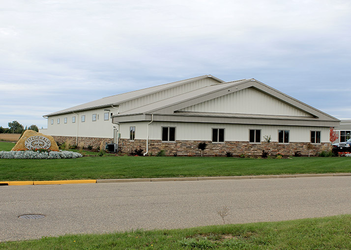 Retail building with steel siding, stone wainscot, and professional storefront design