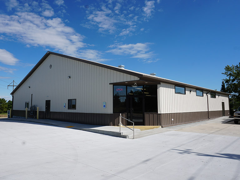 Retail building with steel siding, storefront entrance, and customer access