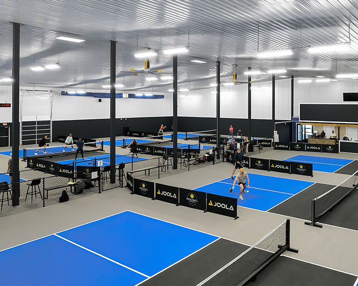 Retail recreation facility interior with clear-span layout, open floor plan, and multiple courts