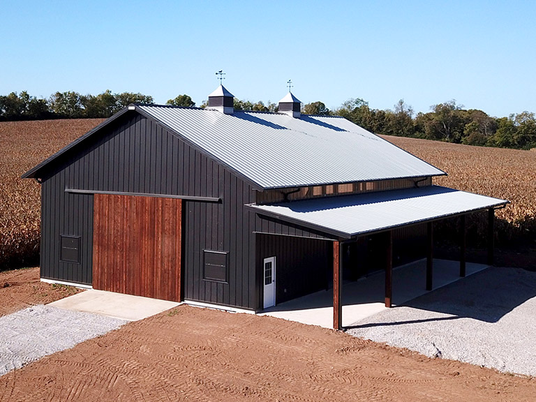 Custom Machinery Storage Building with Lean-To | Walters Buildings Custom machinery storage building with large sliding door and covered lean-to for equipment protection and access