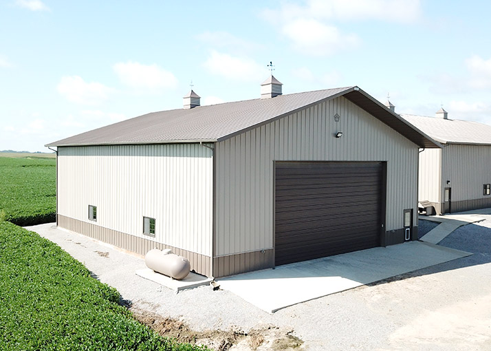 Custom Enclosed Equipment Storage Building | Walters Buildings Custom enclosed equipment storage building with large overhead door for machinery protection and access