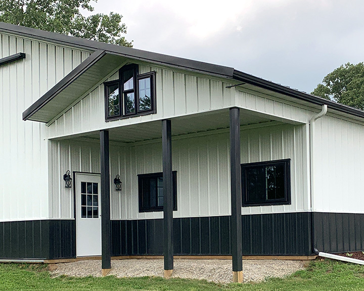 Equipment storage building with covered porch entry and office space designed for operational use