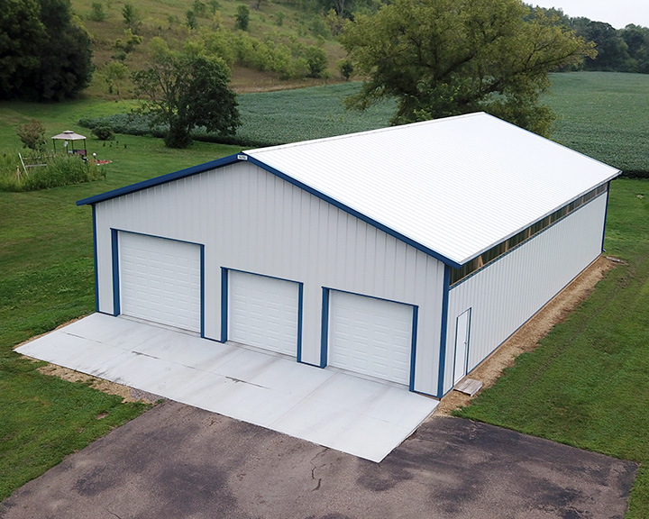 Custom equipment storage building with multiple overhead doors for easy machinery access and organization