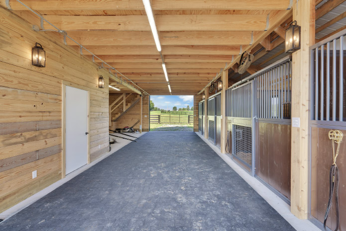 Horse Barn Interior with Aisle and Horse Stalls | Walters Buildings Horse barn interior aisle with wood walls and horse stalls