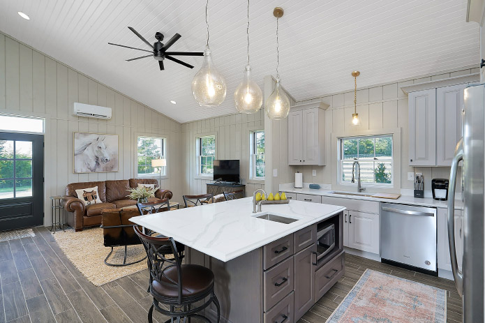 Horse Barn Living Quarters Kitchen with Island | Walters Buildings Horse barn living quarters kitchen and living room with island and pendant lighting