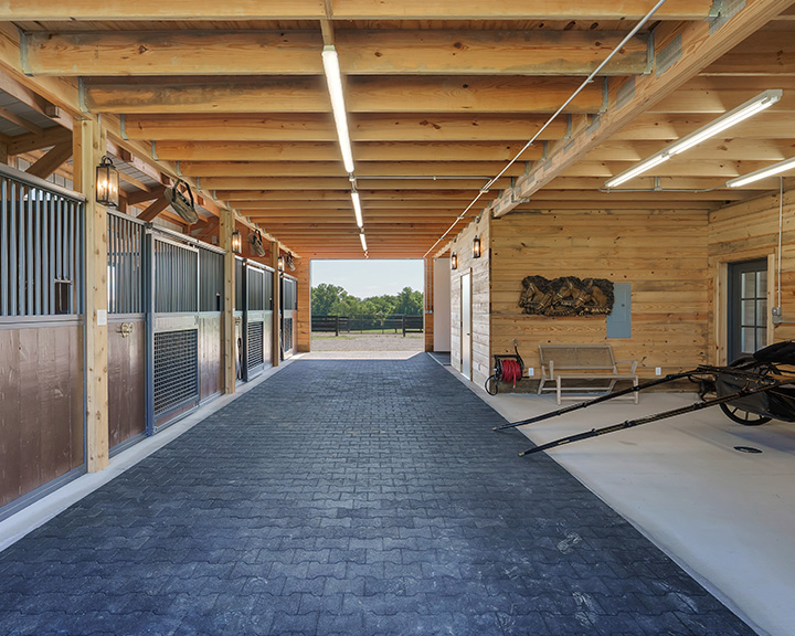 This custom horse barn by Walters Buildings is designed to support equestrian care with a focus on comfort, ventilation, and daily functionality. Featuring a covered porch for protection, cupolas for airflow, and a thoughtfully designed layout, this post-frame structure provides a safe, efficient, and visually appealing environment for horses and their owners.