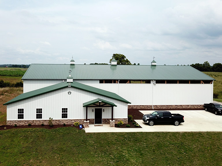 Industrial building with steel siding, high-clearance design, and covered office entrance
