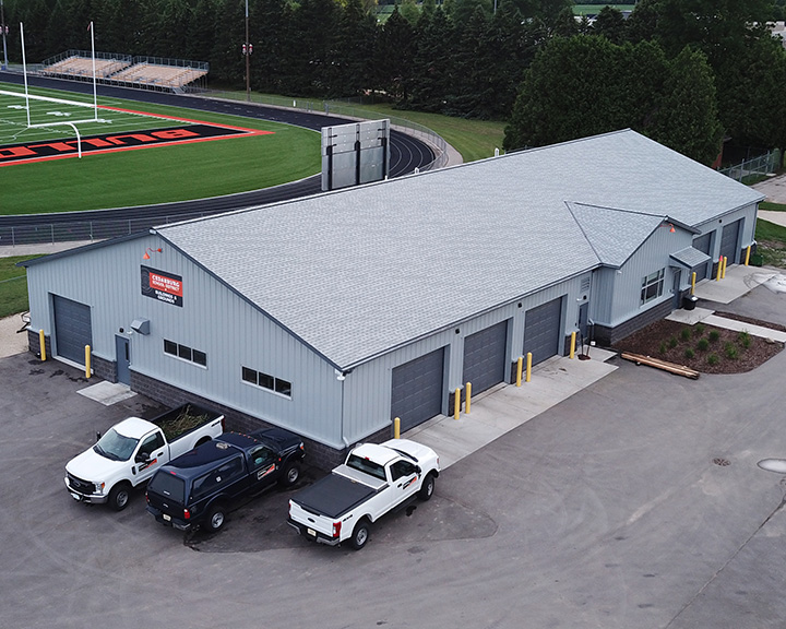 Industrial service building with steel siding, overhead doors, and attached office space