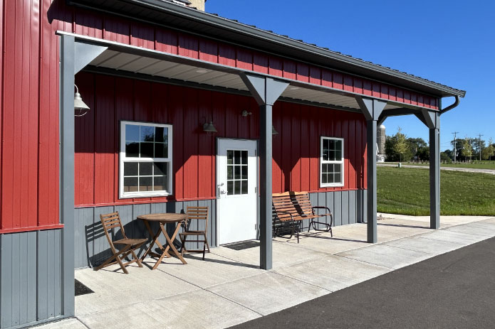 Professional Storage Facility Office in Waukesha Wisconsin | Lone Silo Storage Lone Silo Storage facility office entrance in Waukesha Wisconsin with red post frame building, covered porch, and gray metal roof.