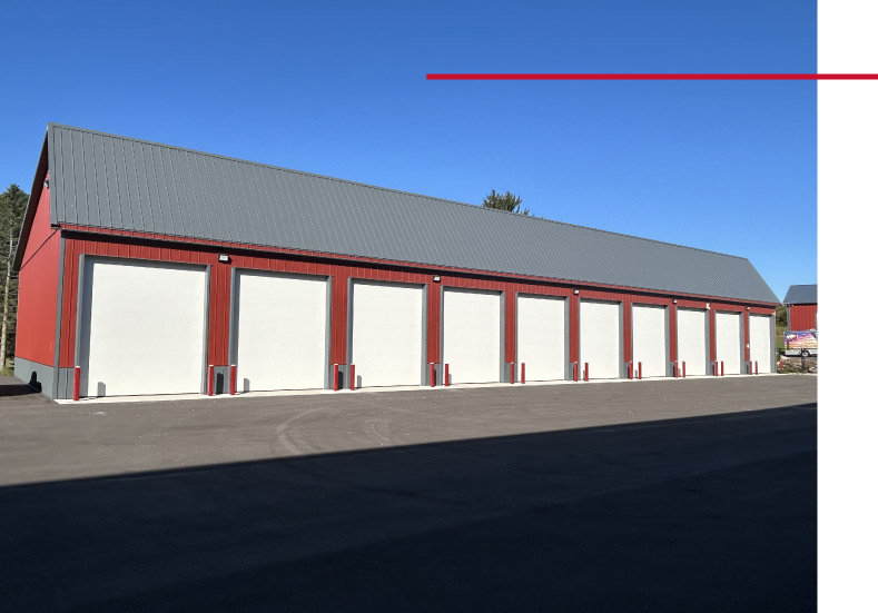 Secure Storage Facilities in Waukesha Wisconsin | Lone Silo Storage Lone Silo Storage facility in Waukesha Wisconsin with a red post frame storage building, gray metal roof, and multiple large storage unit doors.