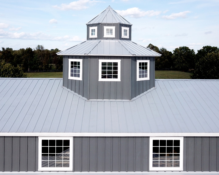 Cupola on indoor riding arena with steel roof and windows for natural light and ventilation