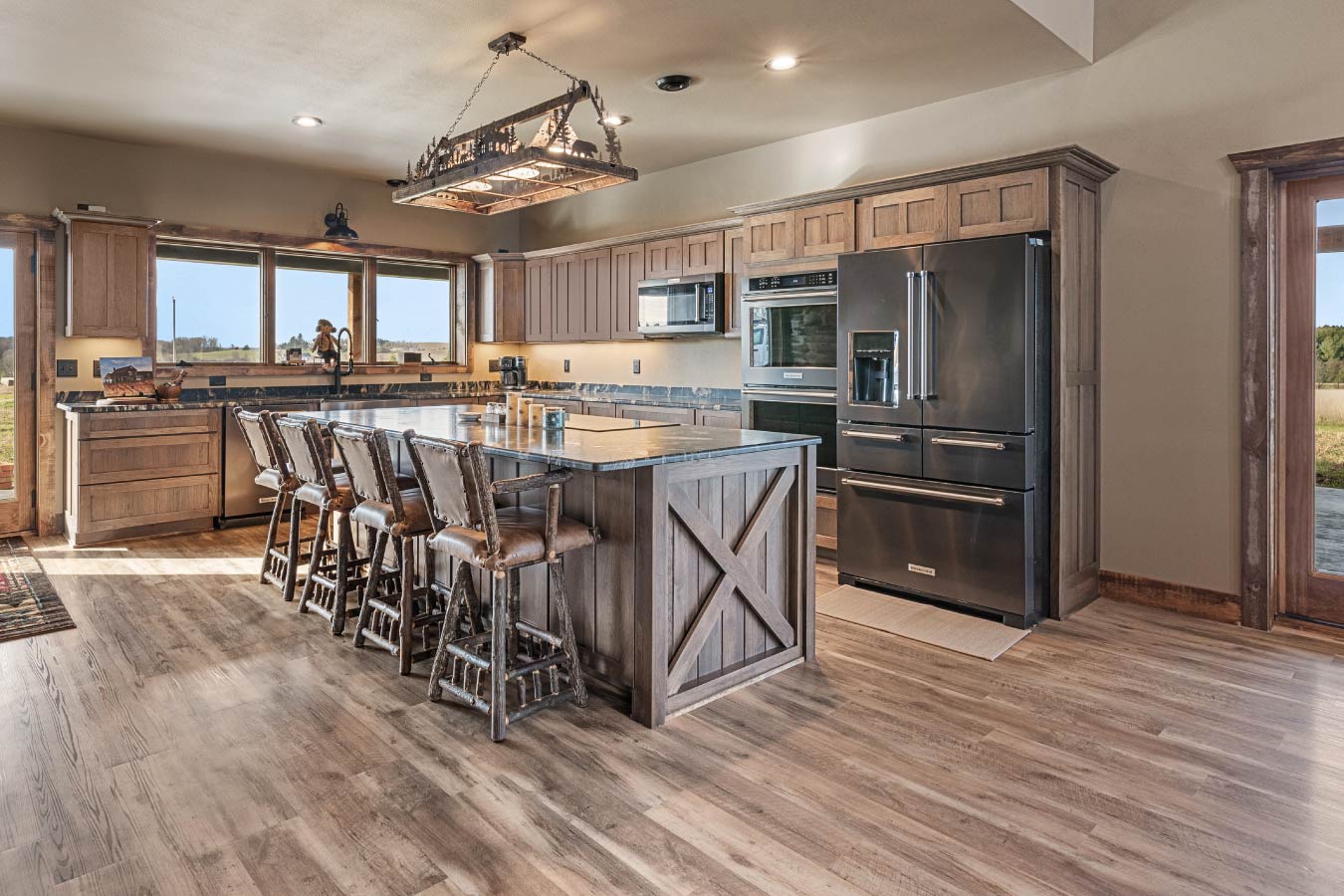 Rustic barndominium kitchen with large island and wood cabinetry