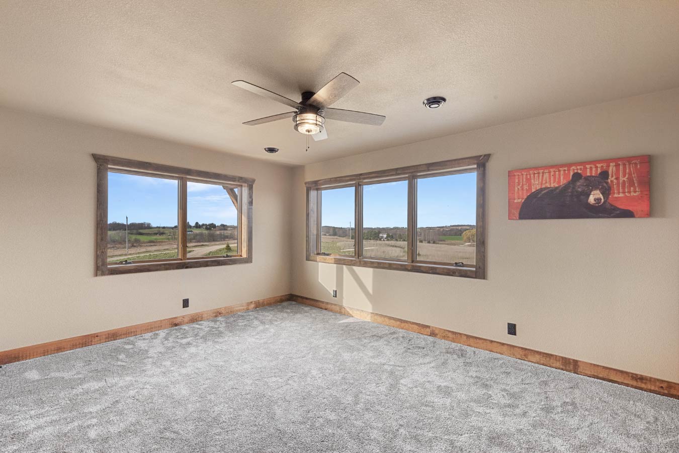 Barndominium bedroom with large windows and countryside views