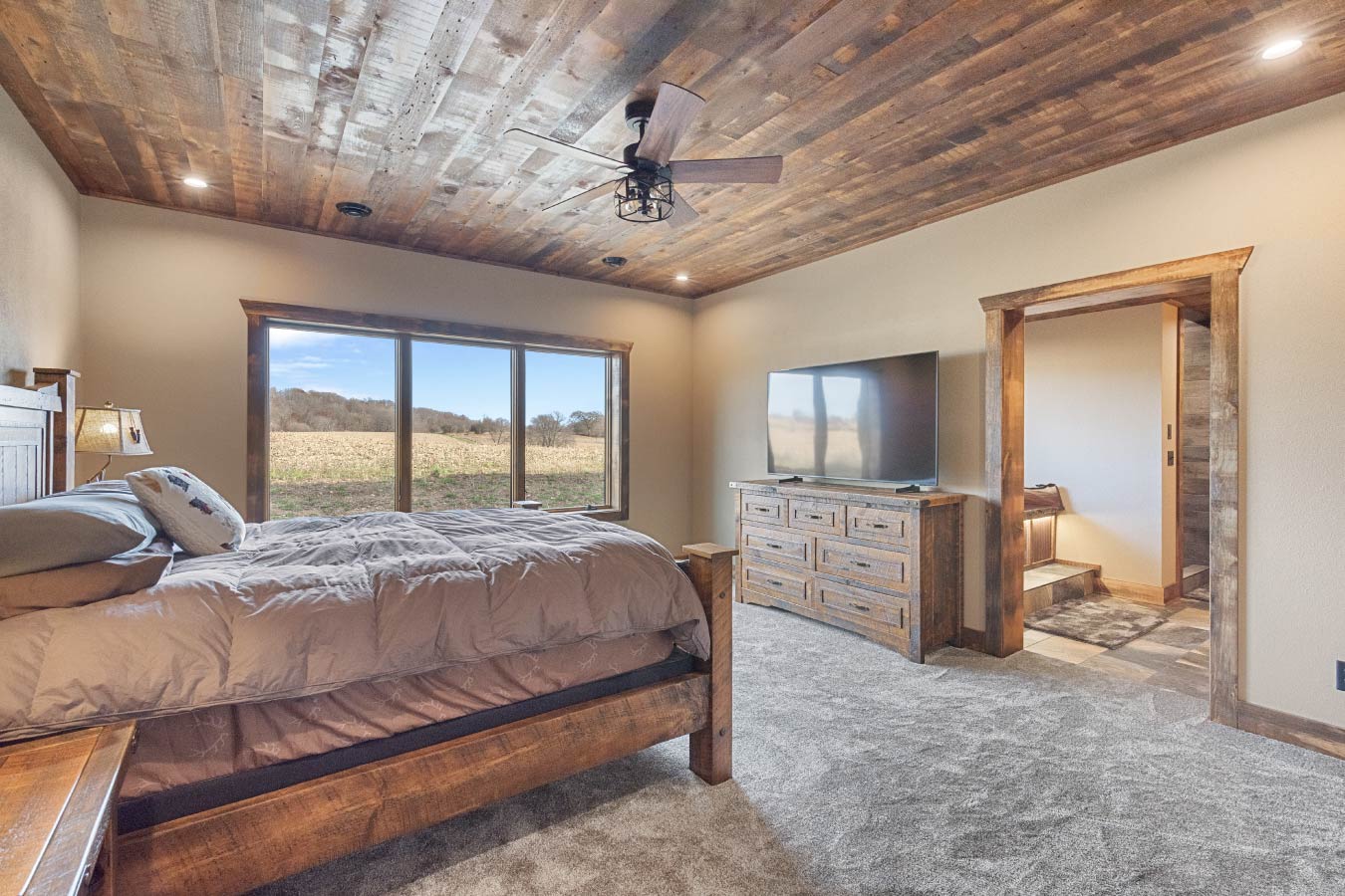 Barndominium Master Bedroom with Rustic Wood Ceiling