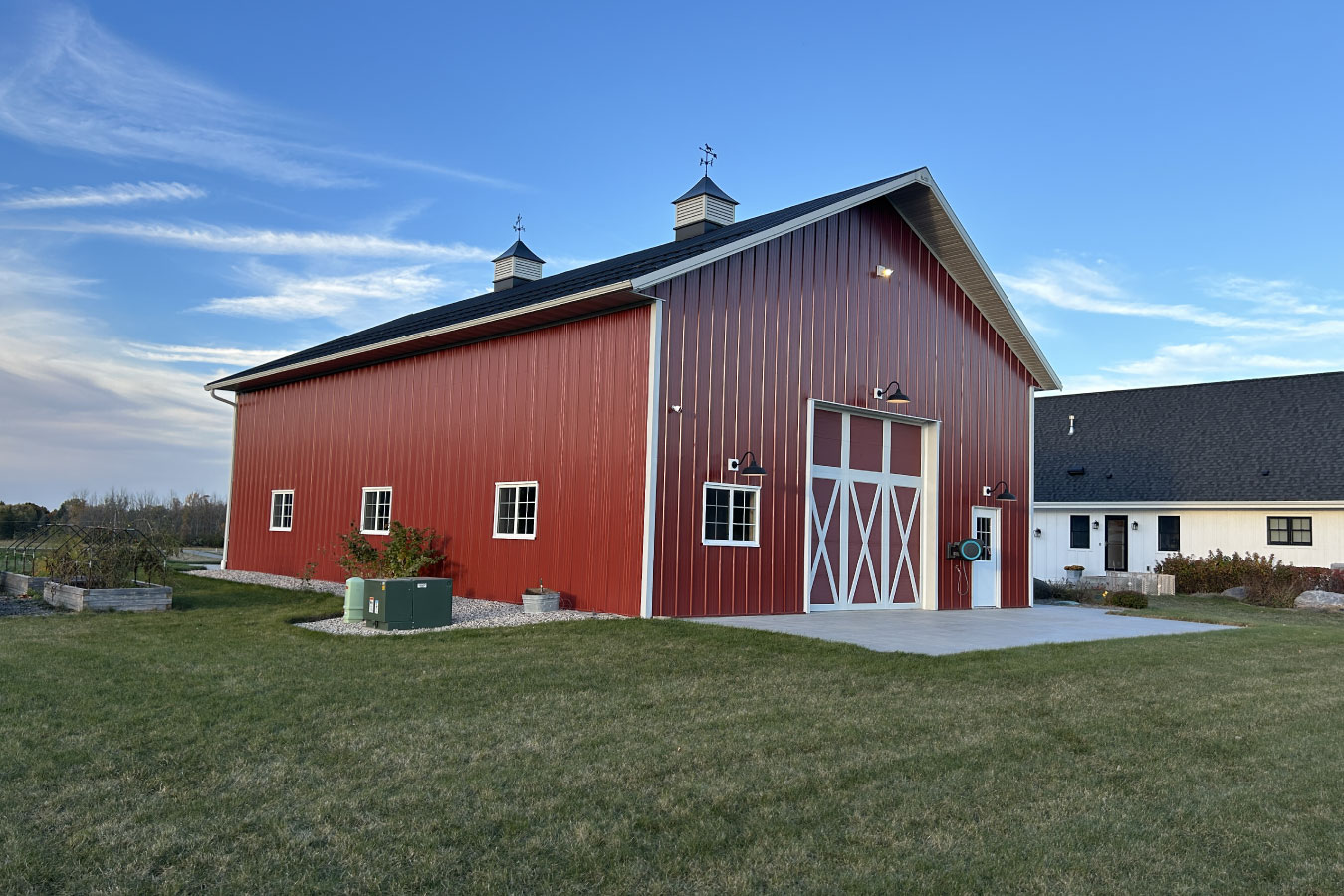 The side elevation of this equipment storage building highlights evenly spaced windows for natural light and durable metal siding. The layout supports efficient equipment storage while maintaining a clean, functional exterior.