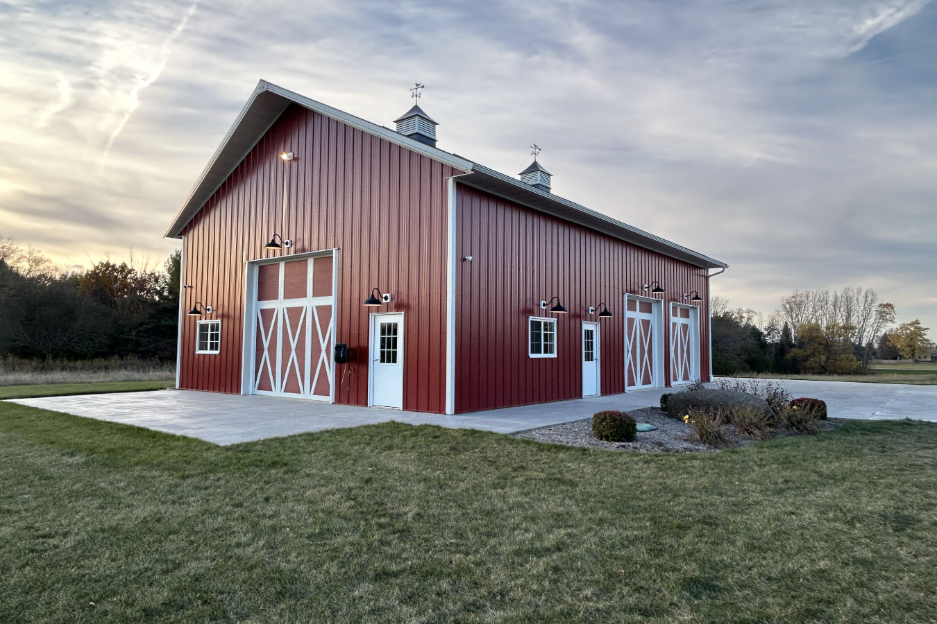 95-1288 Equipment storage building with multiple overhead doors, service doors, and exterior lights