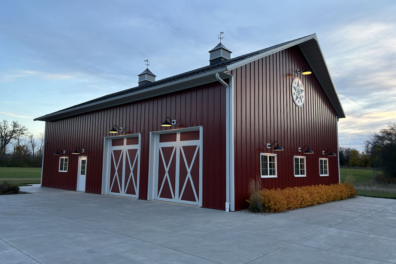 Equipment storage building with overhead doors, exterior lighting, and landscaping