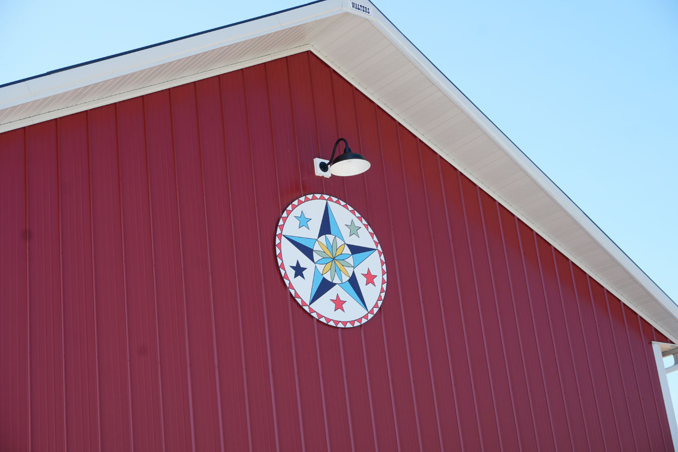 Custom equipment storage building with lighting, overhead doors, and landscaping