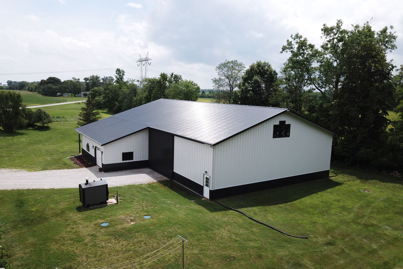 Equipment storage building rear view with large access opening and open surroundings