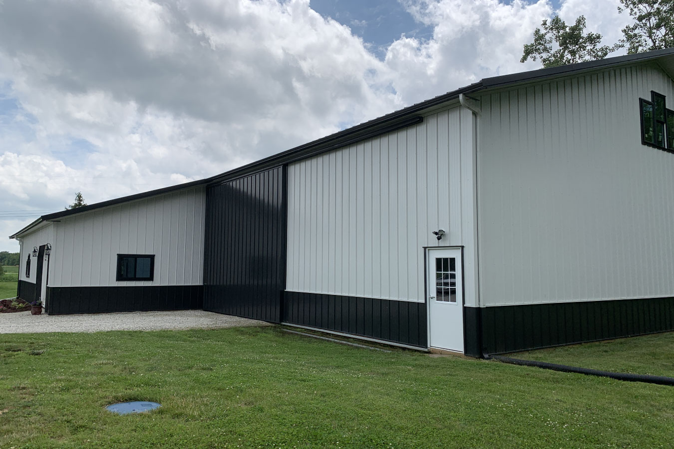 Equipment storage building side view with walk door and continuous wall design
