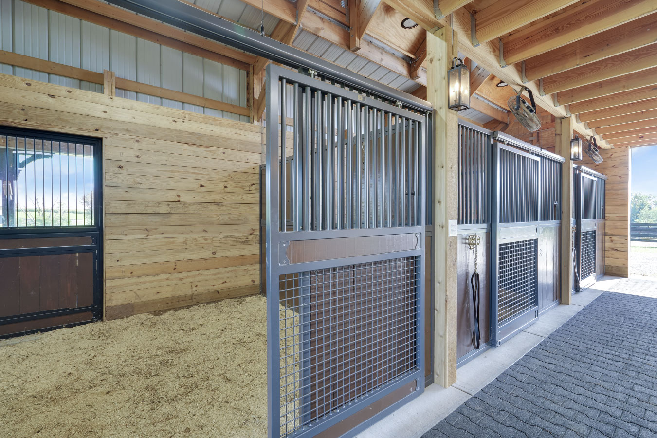 Horse StallsHorse barn interior with metal horse stalls and wood walls