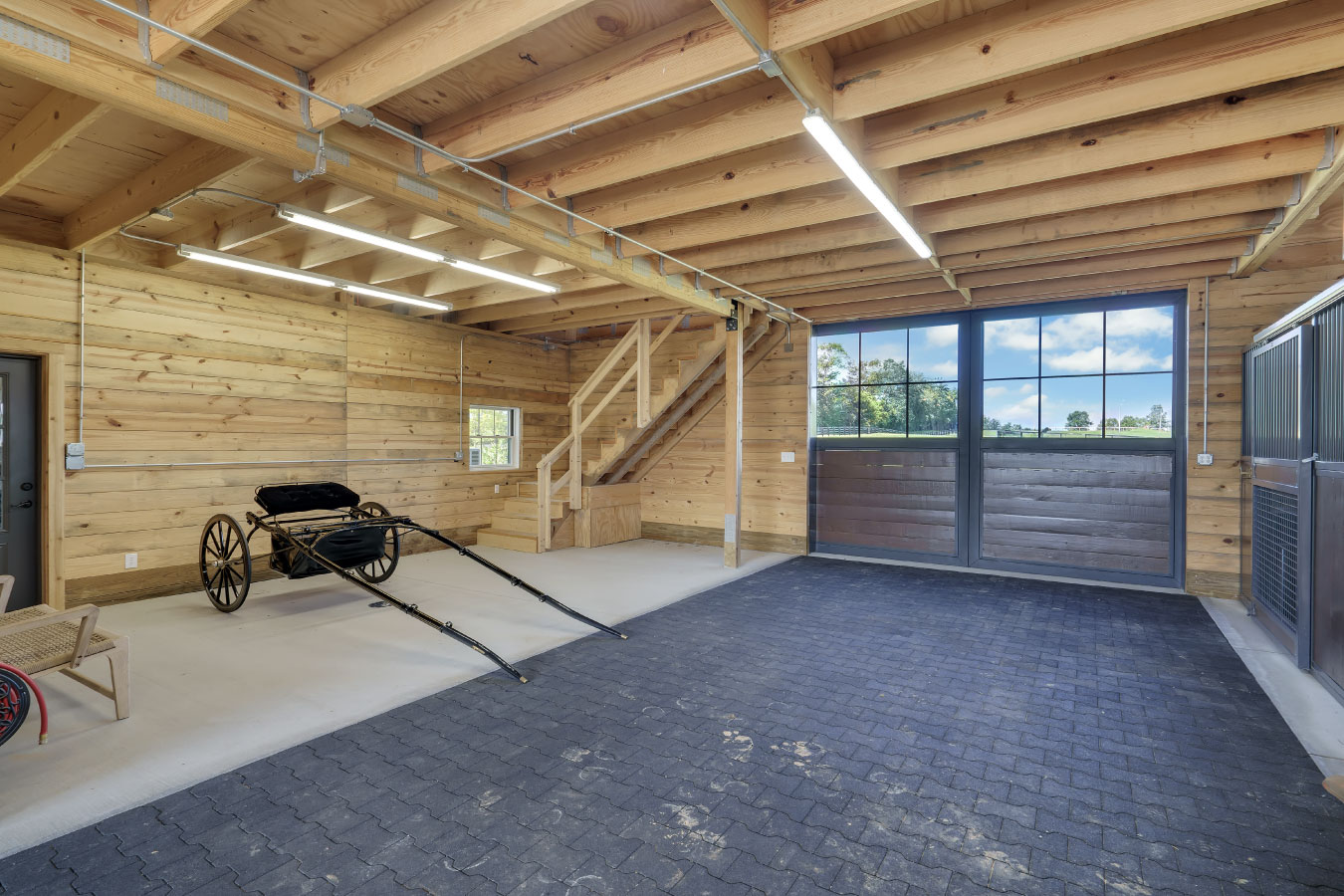 Horse barn tack room and carriage storage area with wood interior