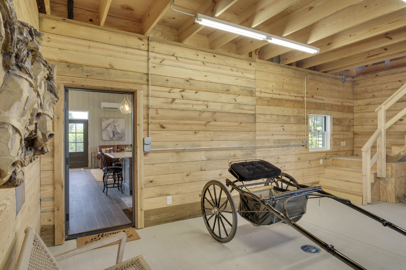 Horse barn carriage storage area connected to living quarters
