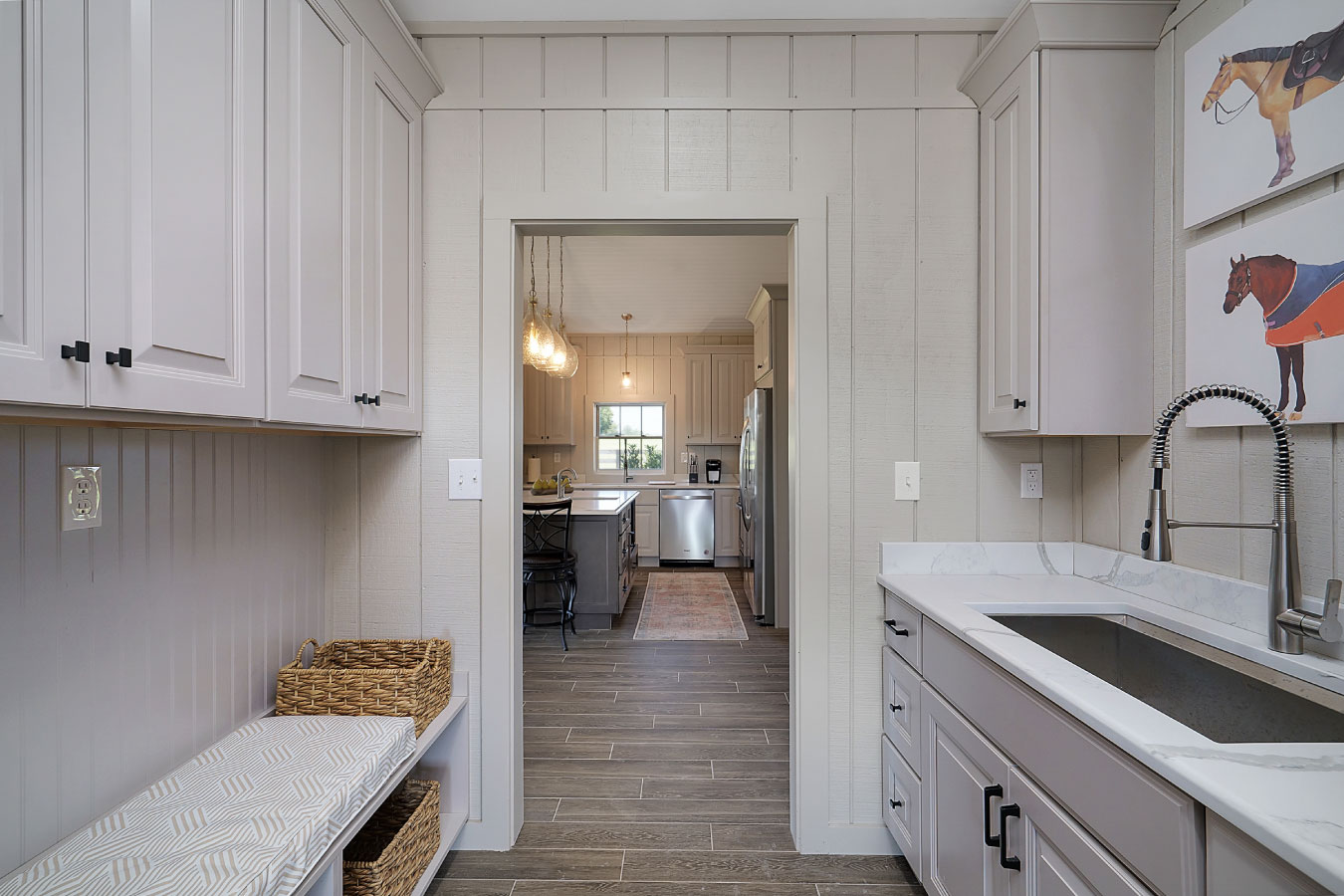 Horse barn living quarters mudroom with utility sink and cabinetry