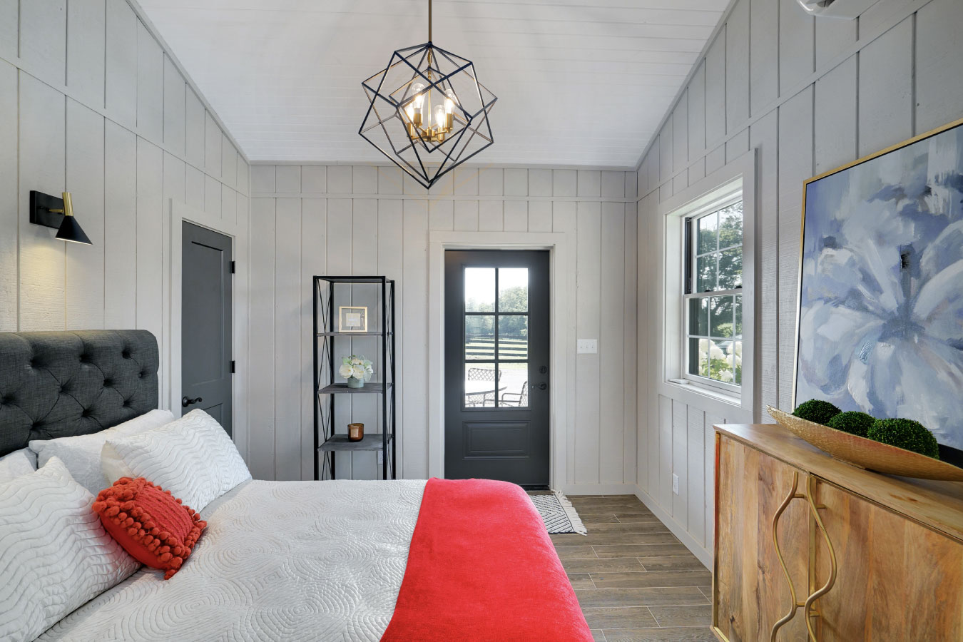 Horse barn living quarters bedroom with patio door and farmhouse interior