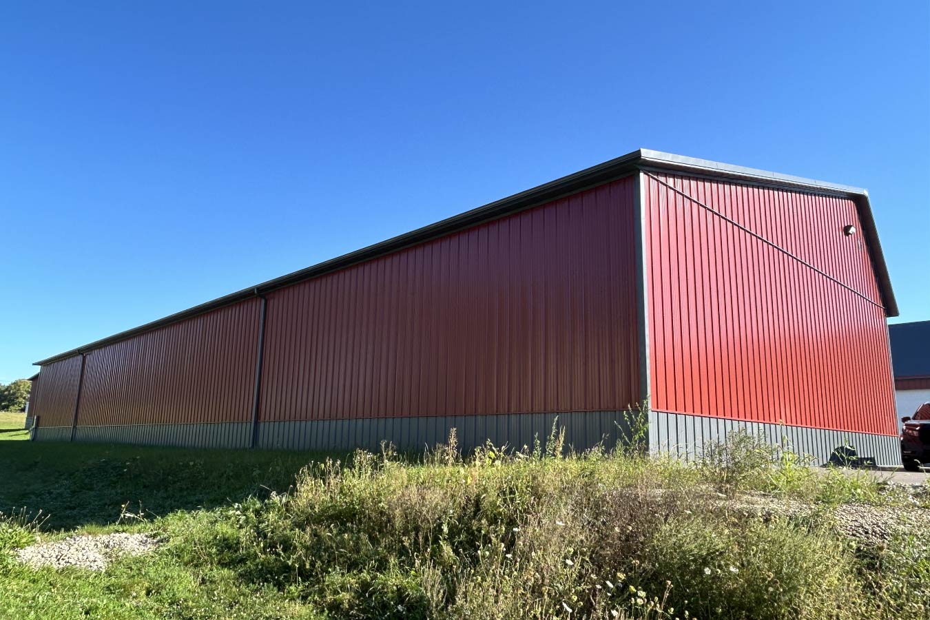 Lone Silo Storage facility in Waukesha Wisconsin featuring a red post frame storage building with gray metal roof and durable steel siding.
