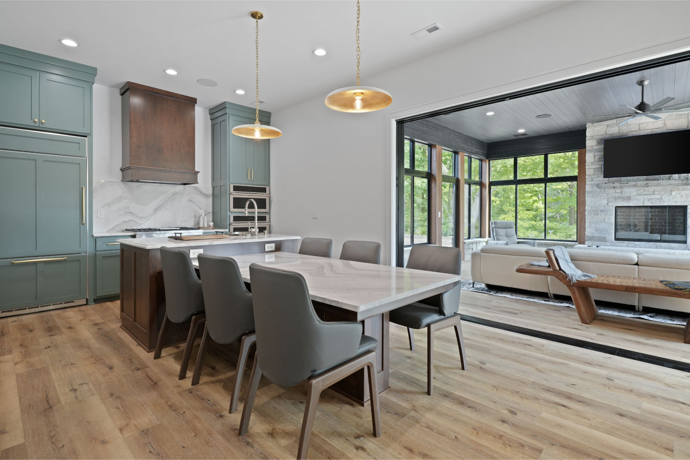 Kitchen and dining area inside a custom monitor barndominium with large island and modern cabinetry