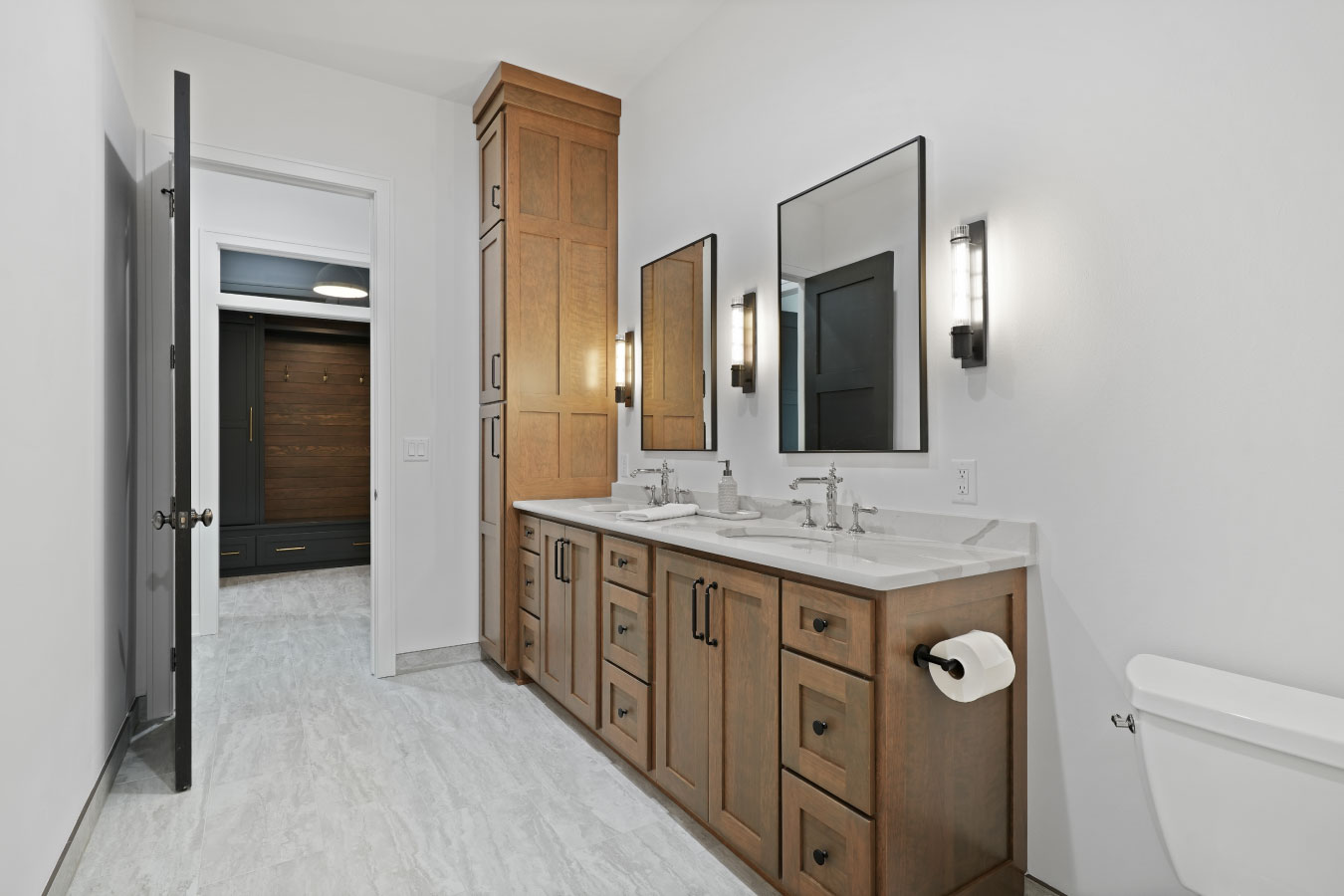 Bathroom vanity inside a custom monitor barndominium with double sinks and wood cabinetry