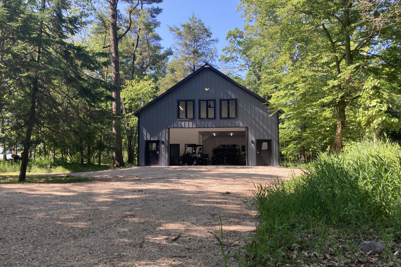 Lakeview Property with a Cabin Shop with living quarters with steel siding, large garage opening, and upper-level windows